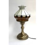 A modern table lamp with Tiffany style shade and glass chimney, 52cmH