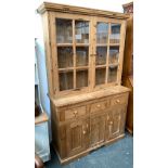 A glazed pine kitchen dresser, the top with two shelves over a base of three drawers and