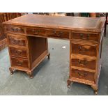 A 20th century kneehole pedestal desk, tooled leather skiver over the traditional arrangement of