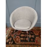 A contemporary grey upholstered tub chair on chrome legs
