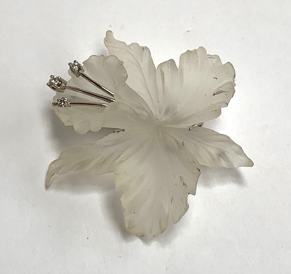 A 14ct white gold, diamond and carved rock crystal brooch in the form of a flower, approx. 5cmL;