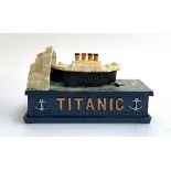 A cast metal novelty 'Titanic' money box, 20cmL