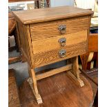 A small oak bedside cabinet, with three drawers, on refectory style base, 45x32x60cmH
