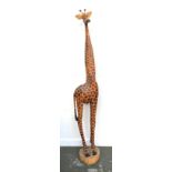 A carved and painted wooden stylised giraffe, 165cmH