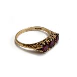 A 9ct gold ring set with three brilliant cut rubies, size P, 2.7g