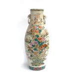 A large Japanese Meiji era satsuma vase, with twin moulded lion mask handles and rings (af),