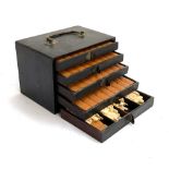 A mahjong set within an ebonised five drawer carry case with brass handle