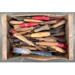 A wooden crate containing a large quantity of files, chisels and gouges