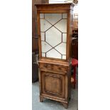 A small astragal glazed bookshelf, with dentil cornice, over two short drawers and a cupboard, on