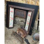 An early 20th century cast iron and tiled fire surround, 98cmW, with grate