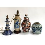 A Chinese blue and white vase converted into a lamp; a Chinese stoneware vase; lidded Imari urn (