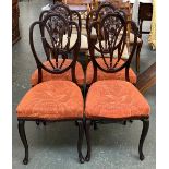 A set of four dining chairs, with stuffover seats