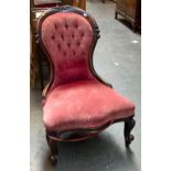 A Victorian button back salon chair with serpentine front and carved cabriole legs