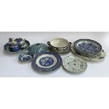 A mixed lot of blue and white ceramics, mainly willow pattern, to include Wedgwood, Cauldon, Spode