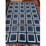 A large geometric blue and white rug, 255x182