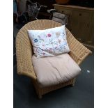 A wicker armchair, 88cmW; together with an embroidered cushion