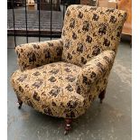 A 19th century armchair, on turned legs and casters, 88cmW