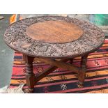 A small Indian occasional table, the top carved with foliage and elephants, 77x47cmH