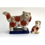 A Staffordshire style cat, 19cmH; together with a small Staffordshire dog, 11cmH