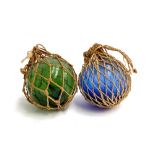 Two glass fisherman's floats, one blue one green