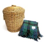 A wicker laundry basket, 49cmH; together with tartan blankets