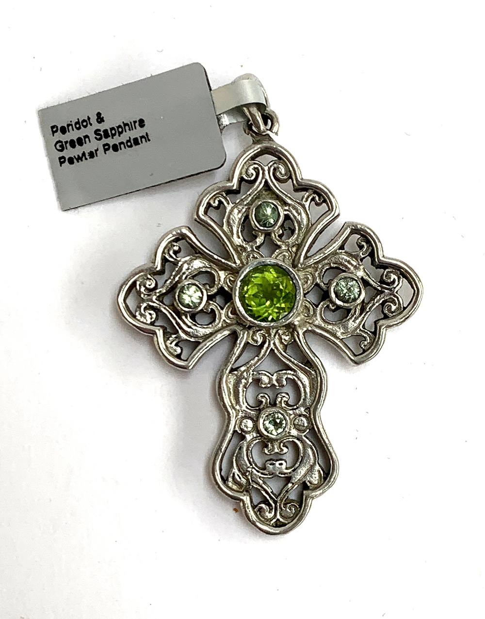 A Stephen Whittard pierced pewter cross set with peridots and green sapphire, 6cmL