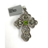 A Stephen Whittard pierced pewter cross set with peridots and green sapphire, 6cmL