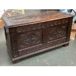 A two panel oak coffer, carved with demilune and lozenge decoration, 90x45x48cm
