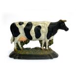 A cast iron doorstop in the form of a standing cow, 21cmH