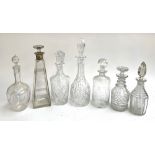 A lot of seven decanters, one of tapered square form, with silver collar by Maxfield & Sons,