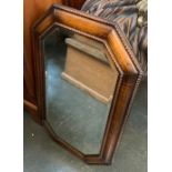 An early 20th century oak wall mirror with canted corners and bevelled glass, 71x45cm