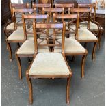 A set of ten Regency style dining chairs, two carvers, with drop in seats, on swept legs