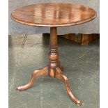 An oak tripod table, turned column on cabriole legs, 61x66cmH