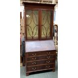 A mahogany glazed bureau bookcase, adjustable shelves over fall front and four graduating drawers,