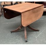 A mahogany dropleaf table on turned column and four swept legs, with brass paw feet and casters,