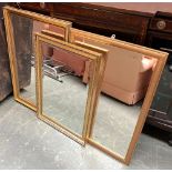Three gilt framed modern wall mirrors, one with bevelled glass, 86x60cm, 83x57cm and 74x51cm