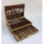 A canteen of stainless steel cutlery with teak handles, 44 pieces