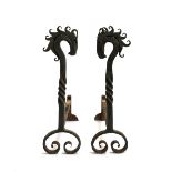 A pair of wrought iron fire dogs in the form of horses, each 55cmH, 53cmD