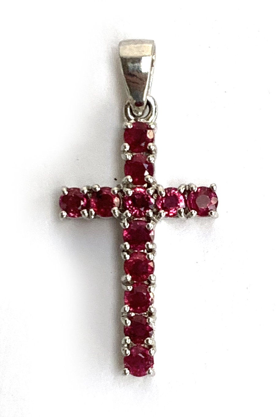 A 9ct white gold and ruby crucifix pendant, 2.8cmL, approx. 2.5g