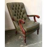 A button back open armchair, in green leather, on turned legs, one caster missing