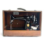 A Singer sewing machine, no. EC228630, in hard carry case