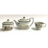 A possibly Newhall miniature three piece tea set comprising teapot, cup and sugar bowl, decorated in