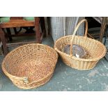 A wicker dog basket, 53cmD; together with three other wicker baskets