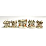 A collection of five Staffordshire encrusted pastille burner cottages, the largest 13cmH (5)
