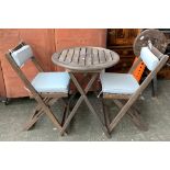 A folding garden table and chairs, with two chairs with cushions