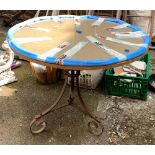 A wrought iron garden table with circular glass top, 91x73cmH
