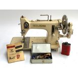 A Frister & Rossman model R sewing machine, retailed by O. Quitmann, together with instructions