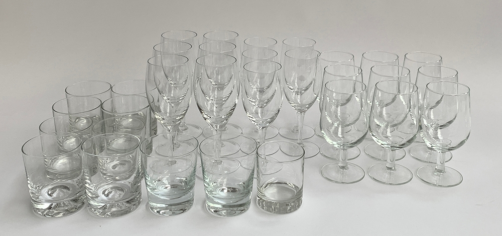 A mixed lot of glassware to include various stemmed wine glasses, whiskey tumblers, and a quantity