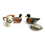 Duck and pheasant lidded tureens, together with two Poole pottery plates with Herring hunting