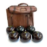 A Slazenger bag containing four lawn bowls by RW Hensell & Sons, made in Australia, 'Henselite'; a